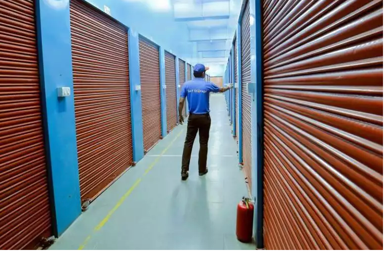 Self Storage India - Corridor with orange roller shutters